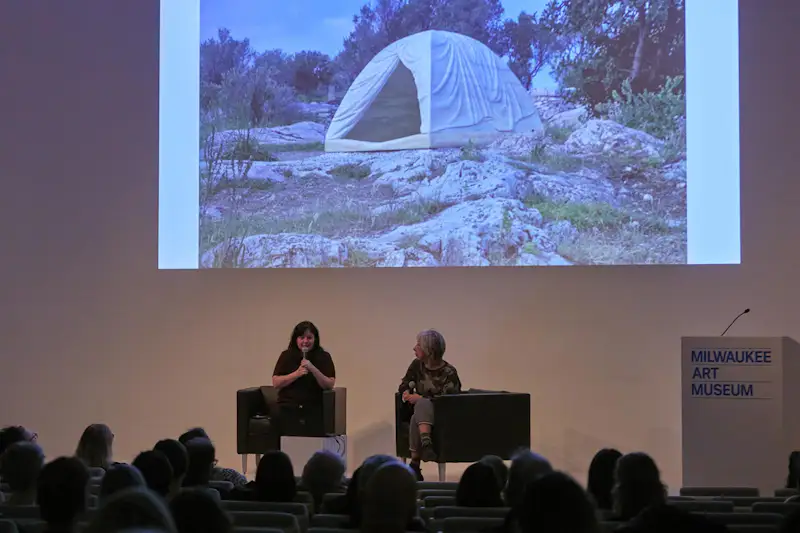 Three women talking on a panel