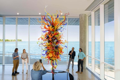 Five museum goers view and discuss Dale Chihuly’s Isola di San Giacomo in Palude Chandelier II near the East End entrance of the museum.
